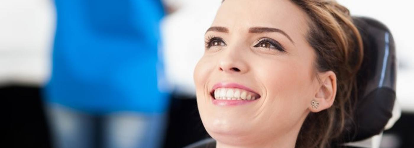 woman smiling in dental chair after getting direct bonding in Lexington