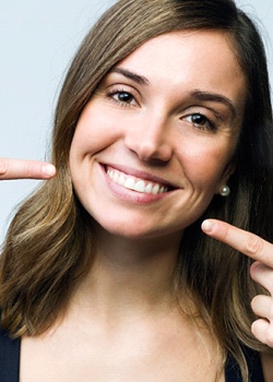 woman pointing to her teeth