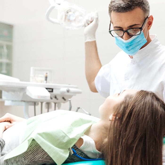 A dentist preparing to look at a patient’s smile