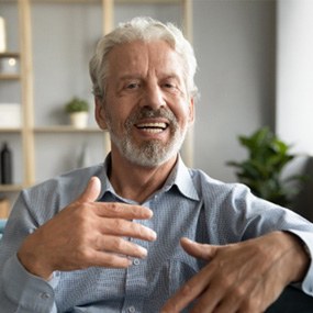 An older man talking with someone off-camera