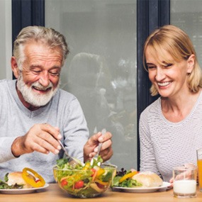 An older couple eating fresh food