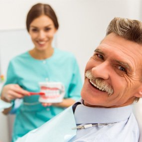 man smiling while visiting dentist  