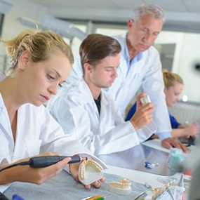 dental technicians working on making dentures