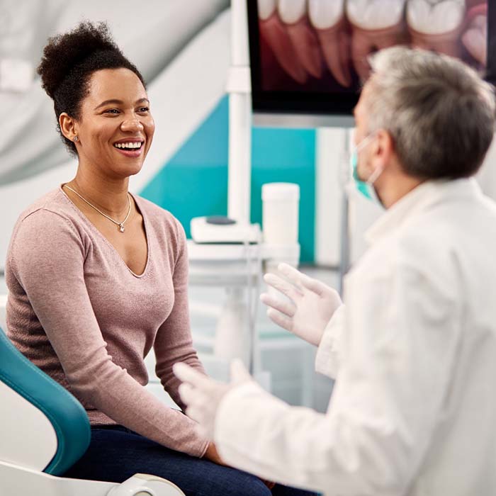 Patient and dentist discussing cost of dental emergencies in Lexington