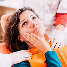 Pained woman visiting her Lexington emergency dentist