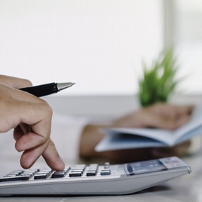 Woman calculating cost of dental emergency in Lexington