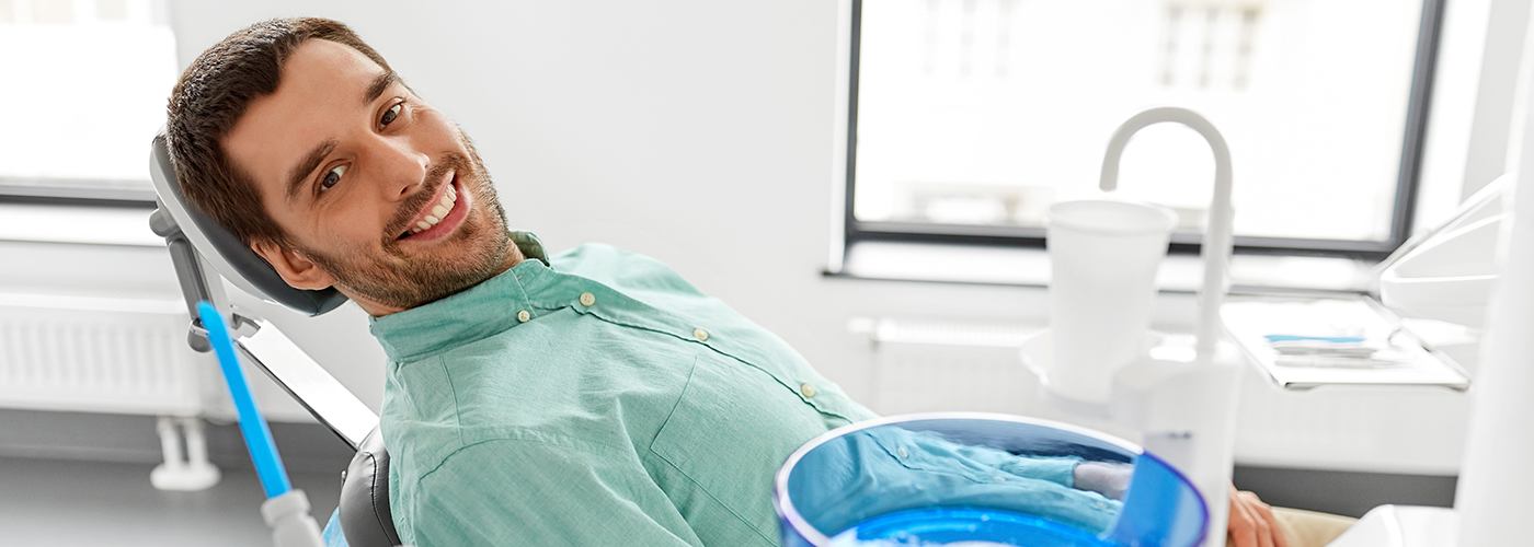 Man in dental chair smiling