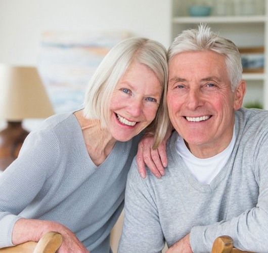 older couple wearing gray sweaters