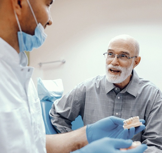 senior man at an implant denture consultation