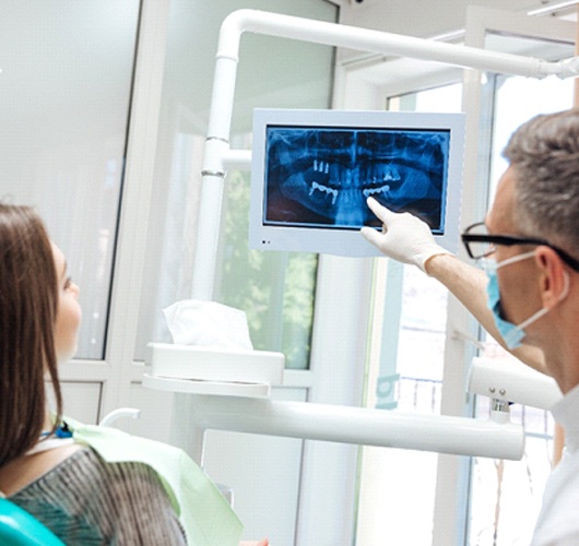 dentist showing a patient their X-rays