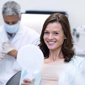 Young woman smiles while visiting her Lexington implant dentist