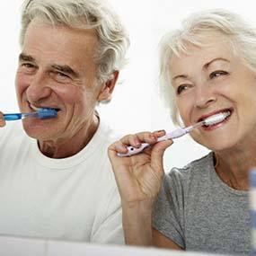 Couple brushing their dental implants in Lexington