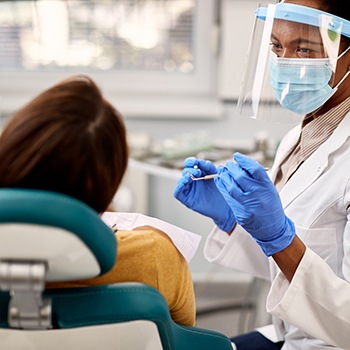 Dentist wearing PPE during exam