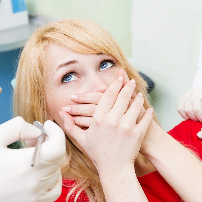 Woman covering her mouth