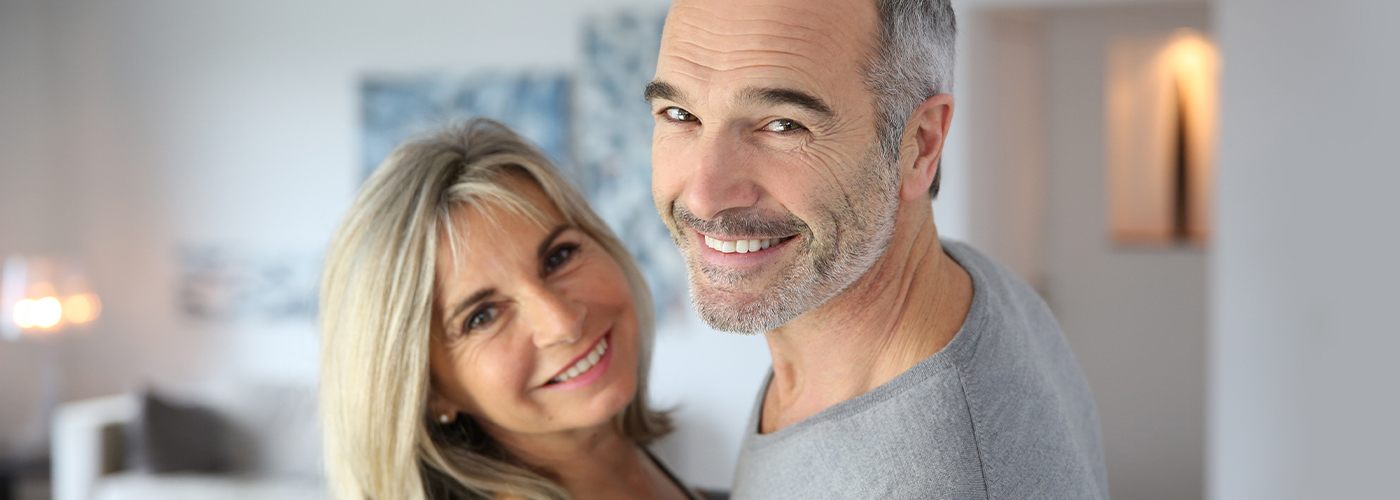 Older man and woman smiling together