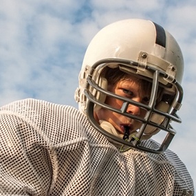 Child wearing mouthguard in Lexington playing football