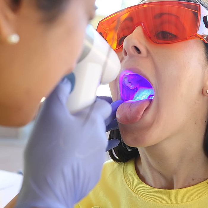 Woman receiving oral cancer screening