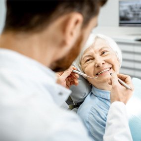 a patient smiling during dental implant consultation in Lexington