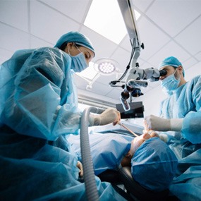 an oral surgeon performing dental implant placement procedure