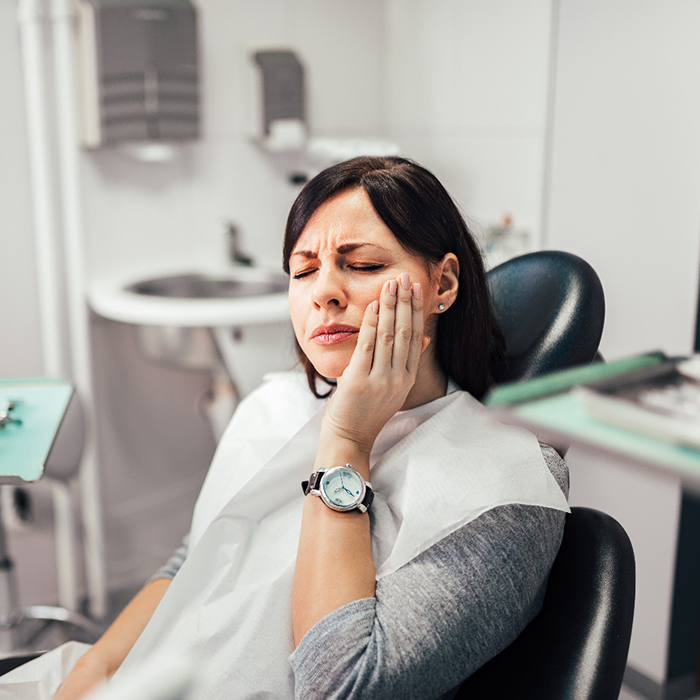 Woman with toothache at dentist's office