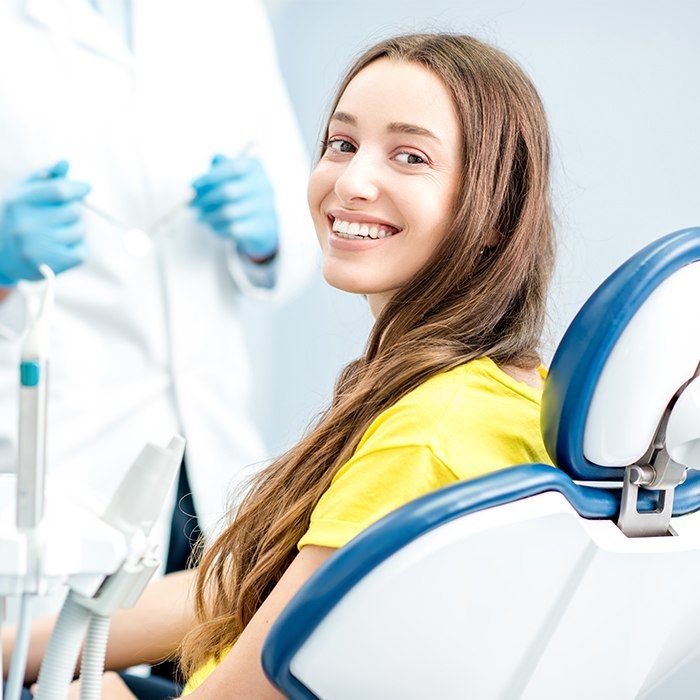 Woman in dental chair smiling