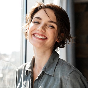 A young woman smiling after successful sedation in Lexington