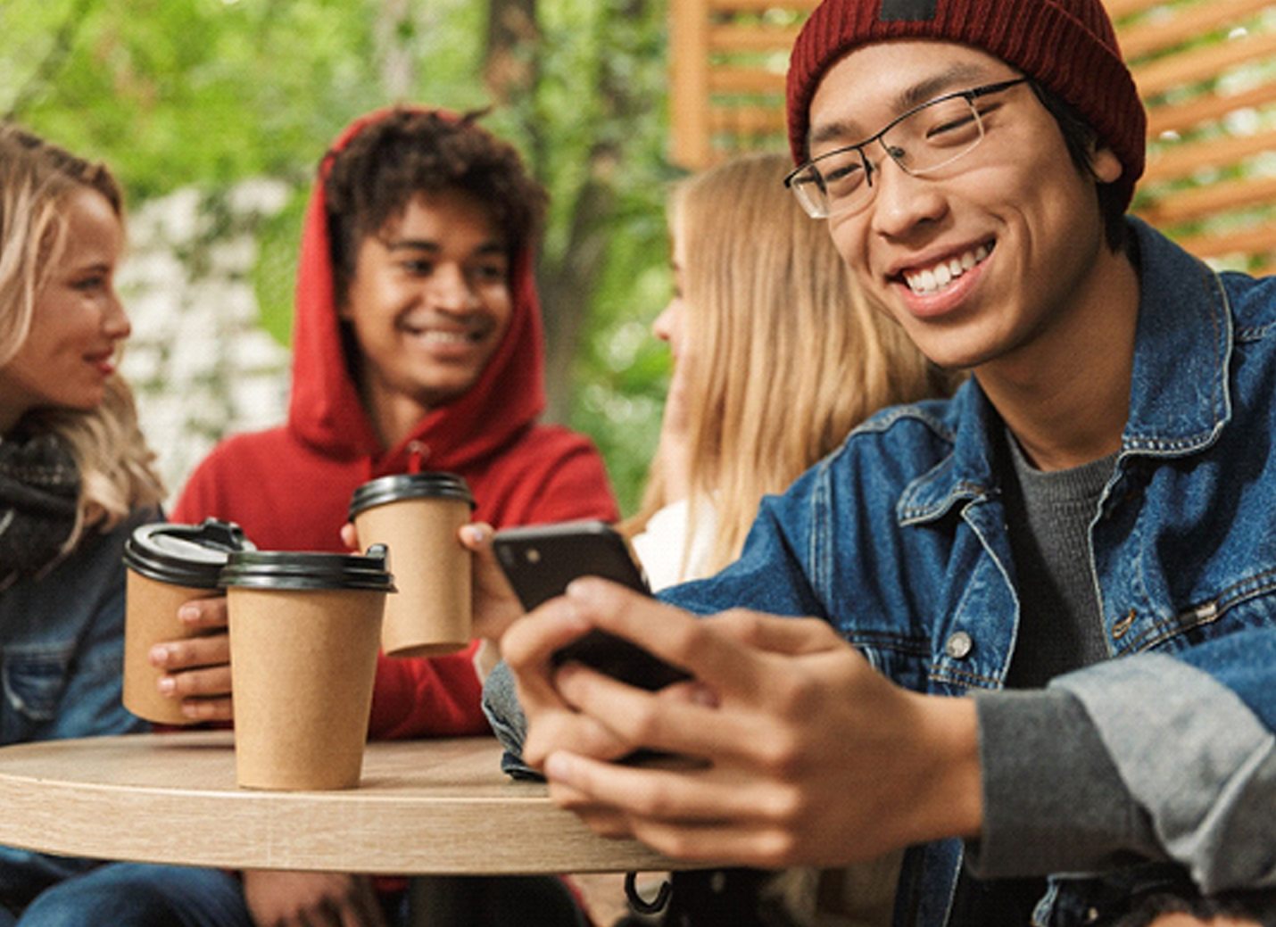 person smiling and looking at their phone