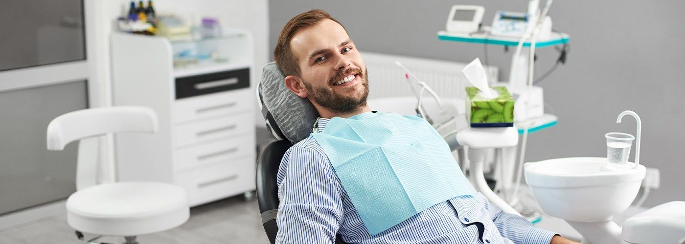 Man in dental chair smiling