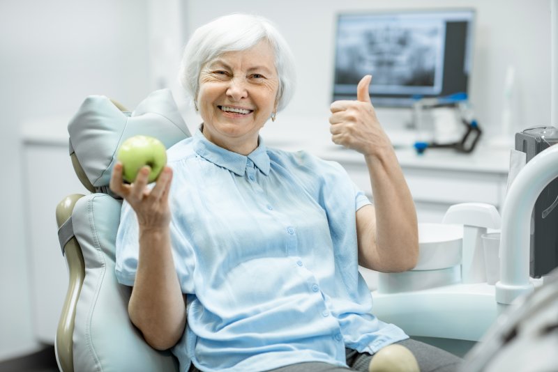 Female patient smiling with dental implants