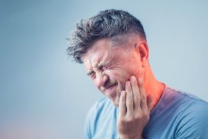 man in pain who needs emergency dentist in Lexington