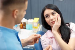 woman with a toothache talking to her emergency dentist in Lexington