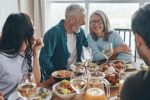 family members smiling with dental implants during Thanksgiving dinner